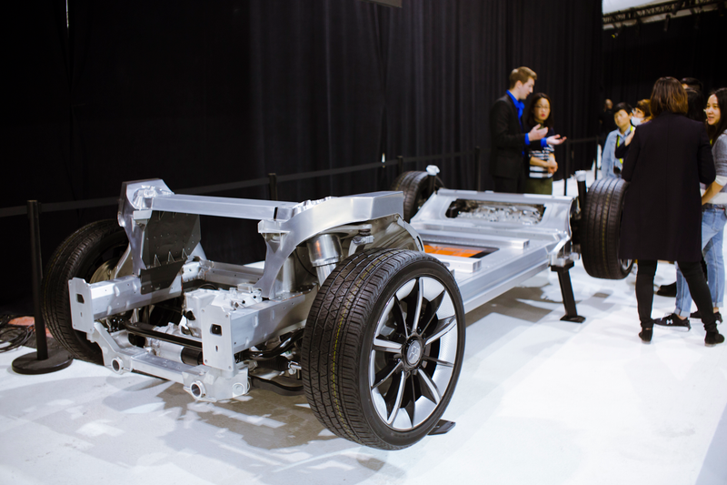 The FF 91's skateboard chassis. Note the modular front strut bracing, the two electric motors in the back, and the orange batteries laid out in six crosswise strings. Photo Credit: Raphael Orlove
